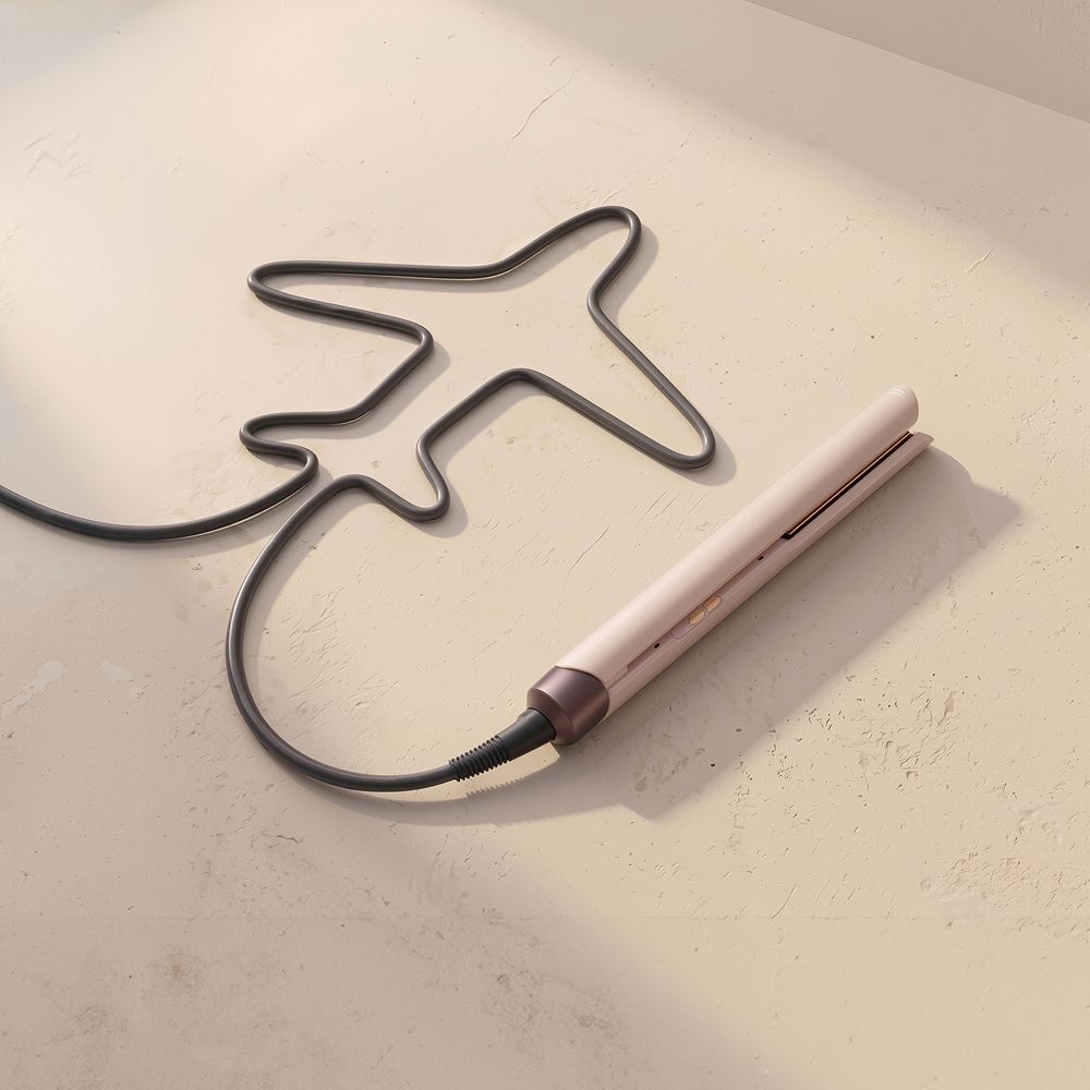 A Dyson Beauty device with cable shaped like an airplane.