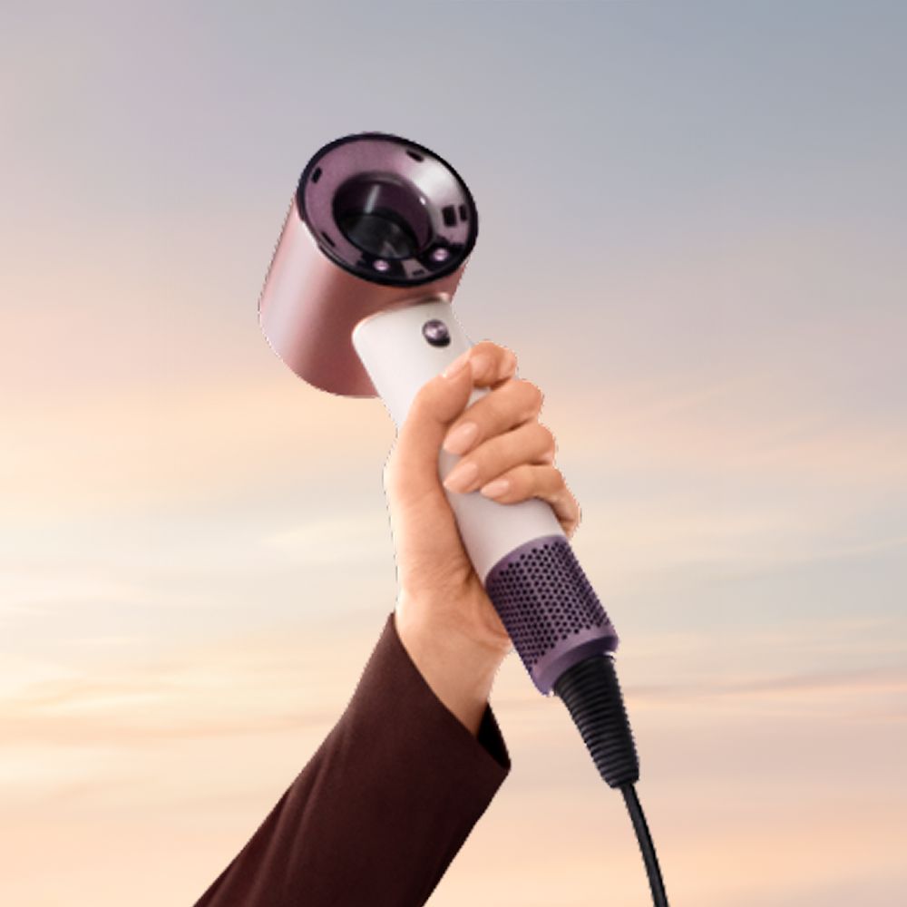 Dyson Supersonic Travel hair dryer held in a hand.