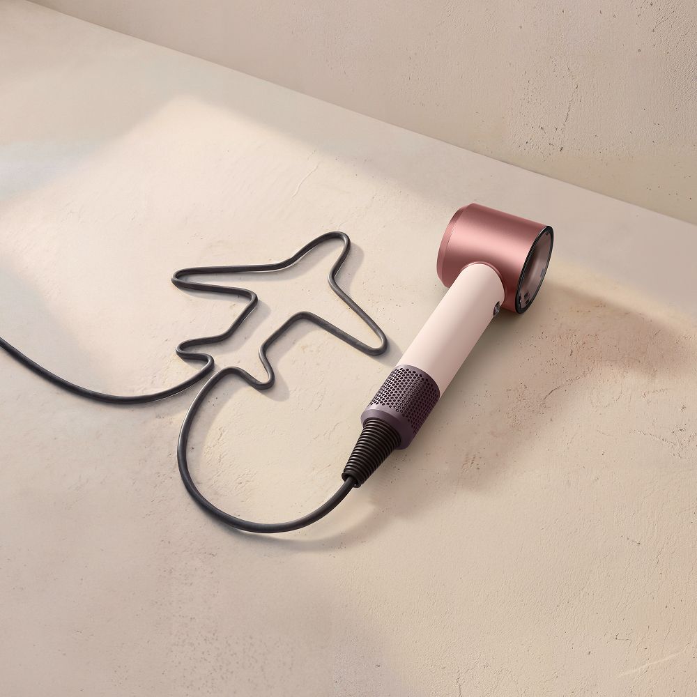 Dyson Supersonic Travel hair dryer with the cable in the shape of an aeroplane.