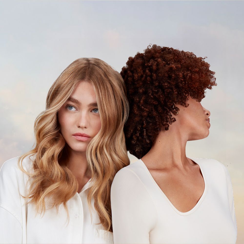 A pair of models with their hair styled with Dyson Beauty devices and products.