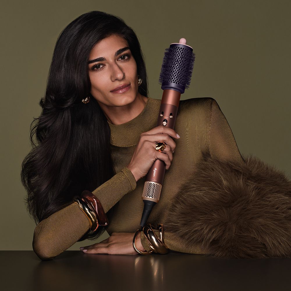 Model holds the Dyson Airwrap i.d. multi-styler and dryer.