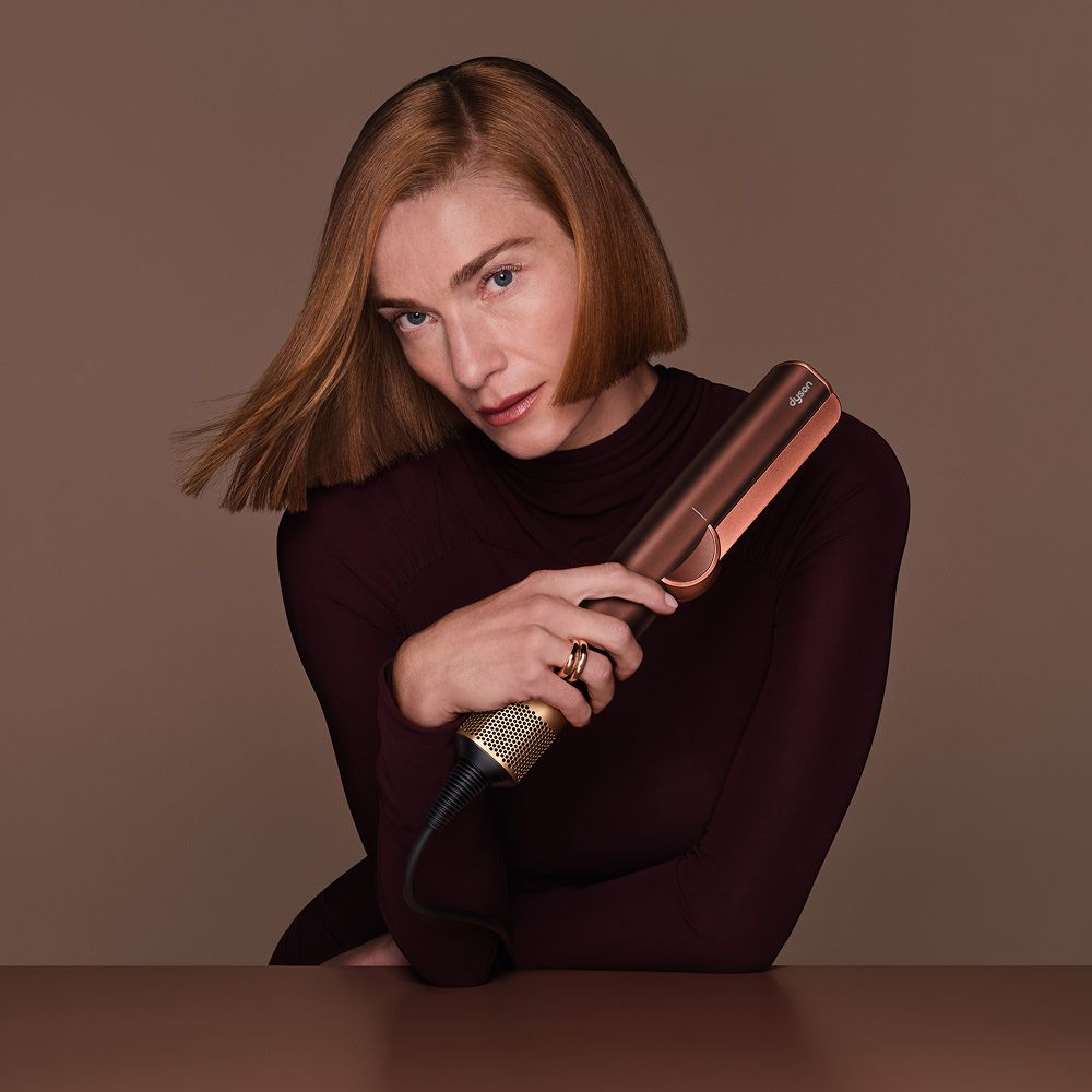 Model holds the Dyson Airstrait dryer and straightener.