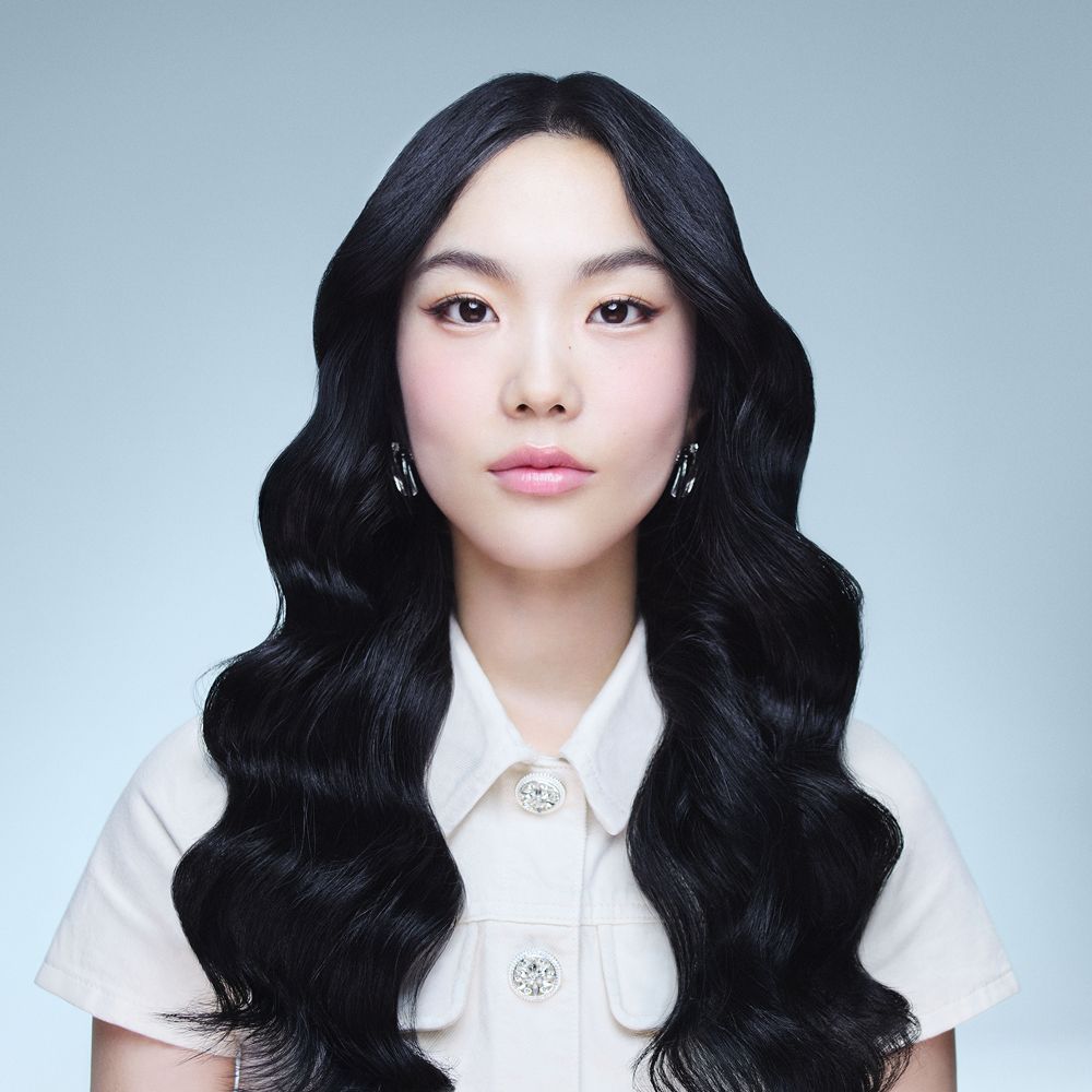 Model with hair styled using the Dyson Airwrap Co-anda2x multi-styler and dryer.