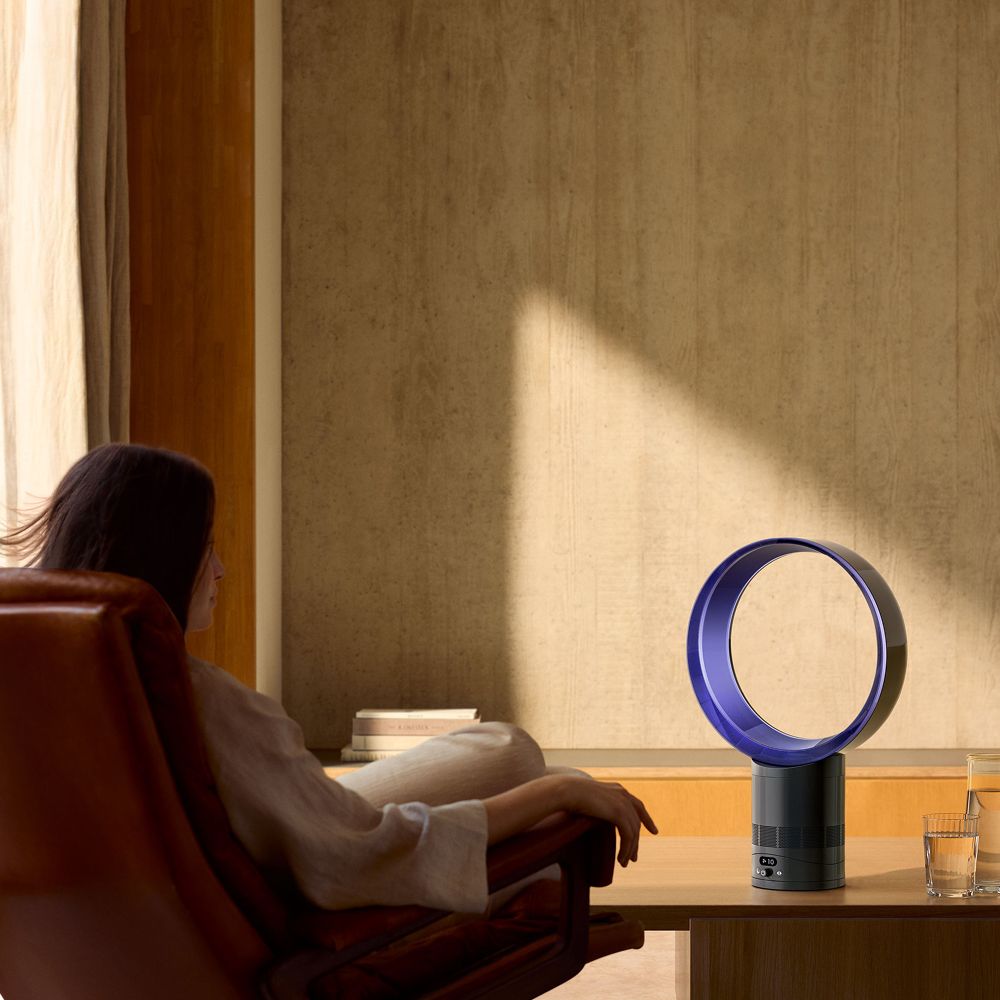 The Dyson Cool CF1 delivers a cool breeze to a person in a chair.