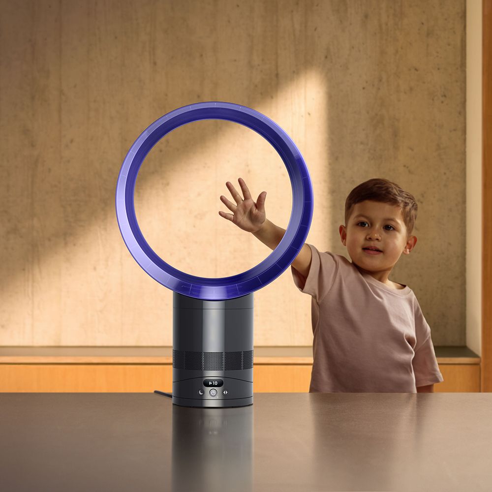 A child feeling the airflow of the Dyson Cool CF1 fan without blades.