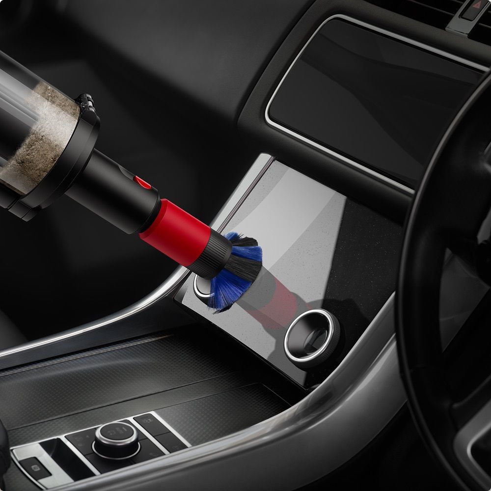 The Scratch-free dusting brush is used to clean a screen in a car.