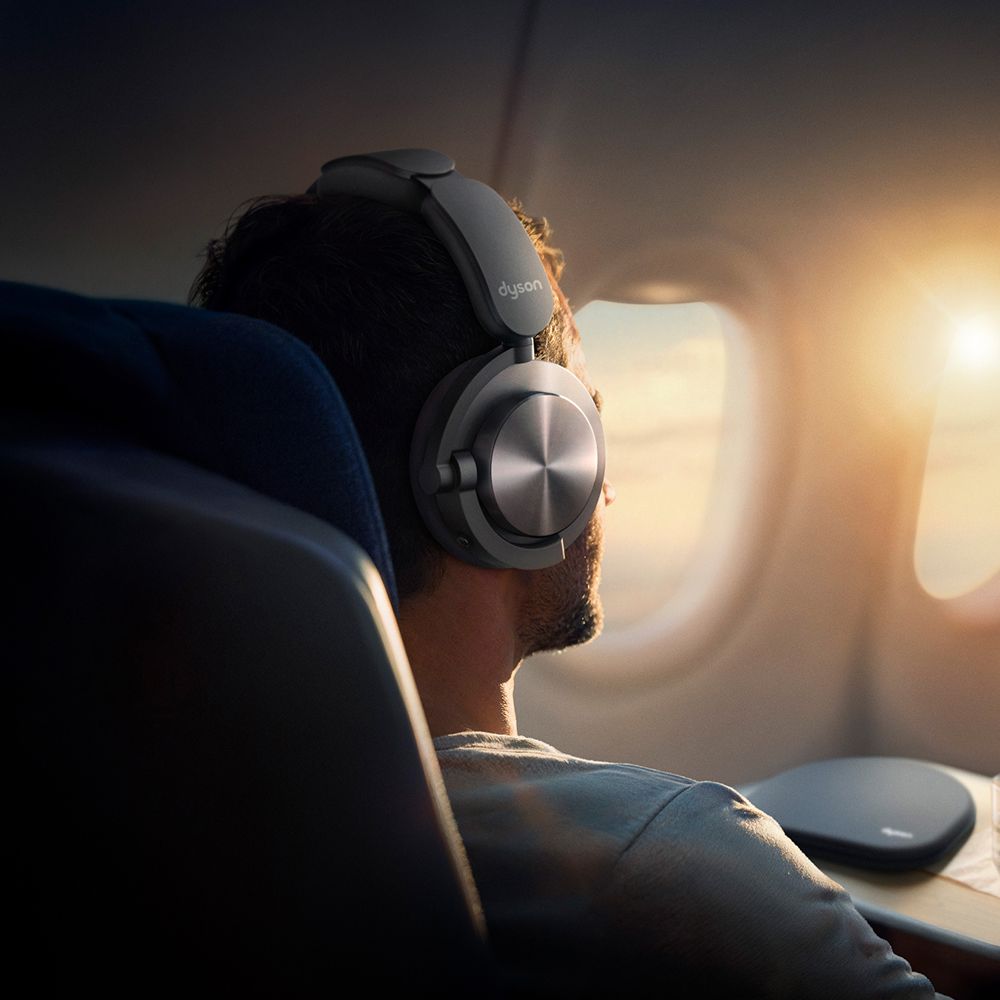 A person relaxing on a plane with ontrac headphones.