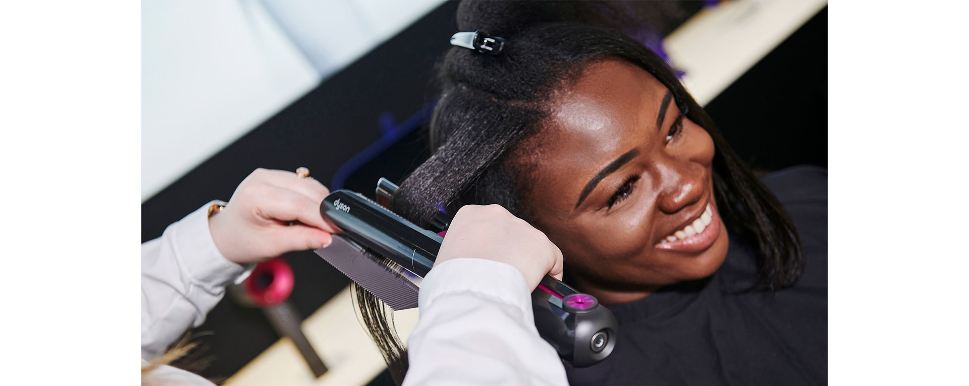 Dyson stylist helping someone with a demo