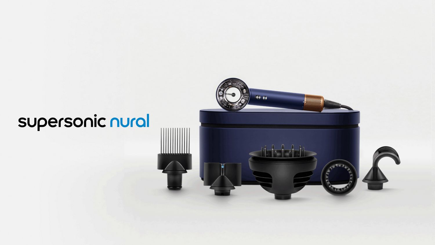 The Dyson Supersonic Nural hair dryer resting on a presentation case behind a range of accessories.
