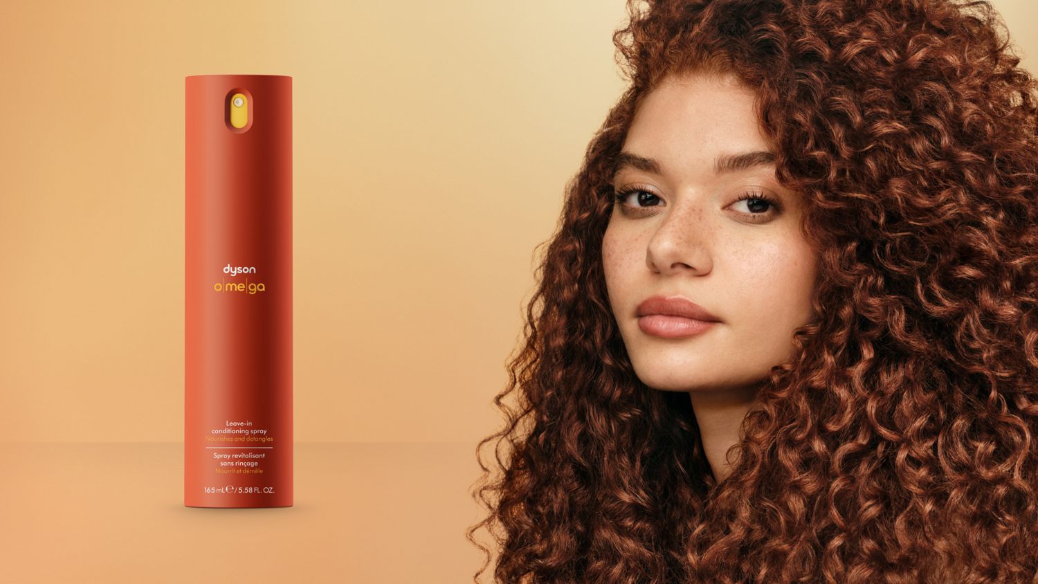 Dyson Omega leave-in conditioning spray next to a model with nourished hair.