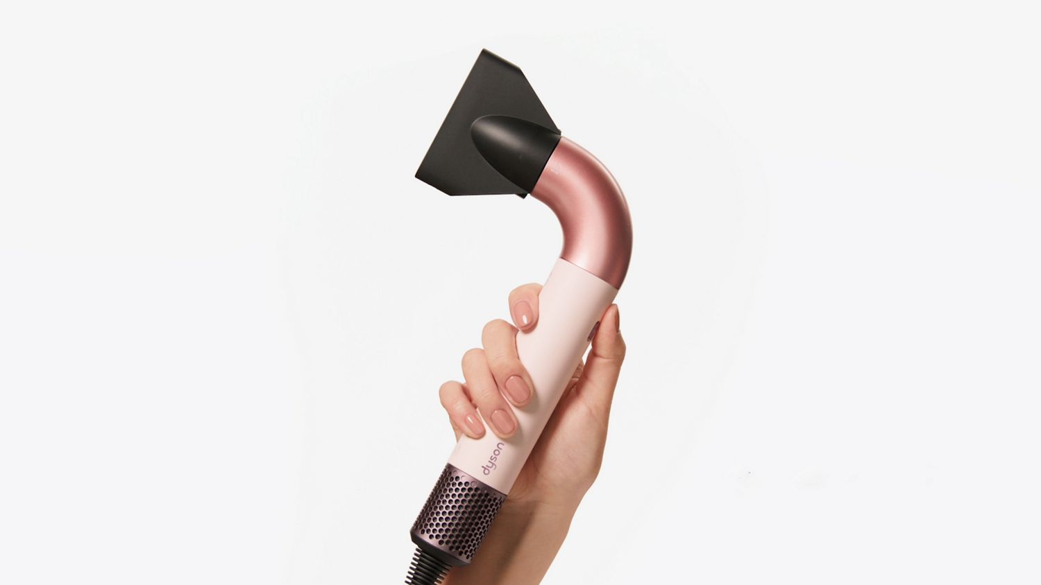 The Dyson Supersonic r hair dryer held in a hand.