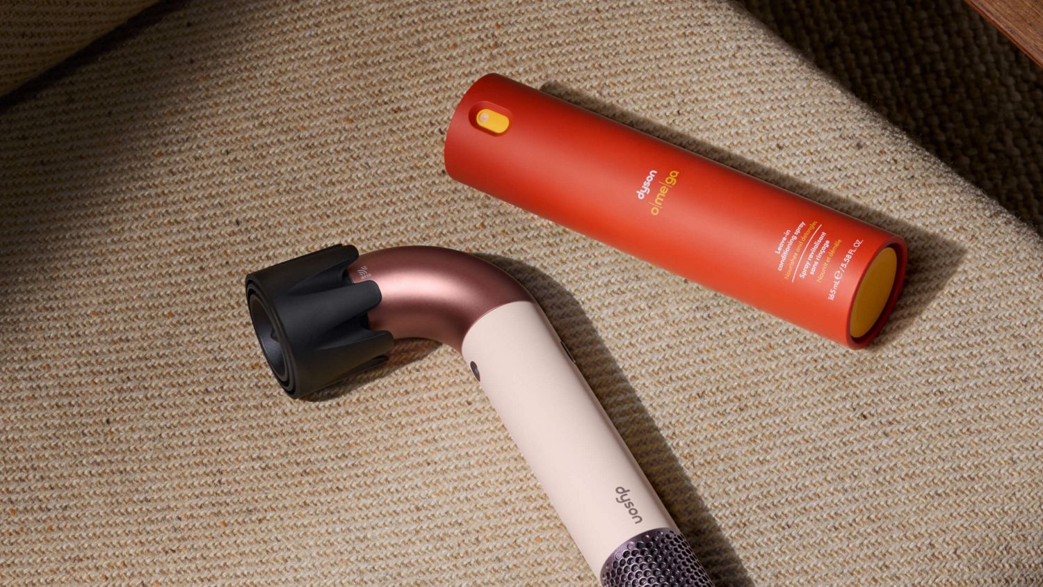 Dyson Supersonic r hair dryer and Dyson Omega leave-in conditioning spray.