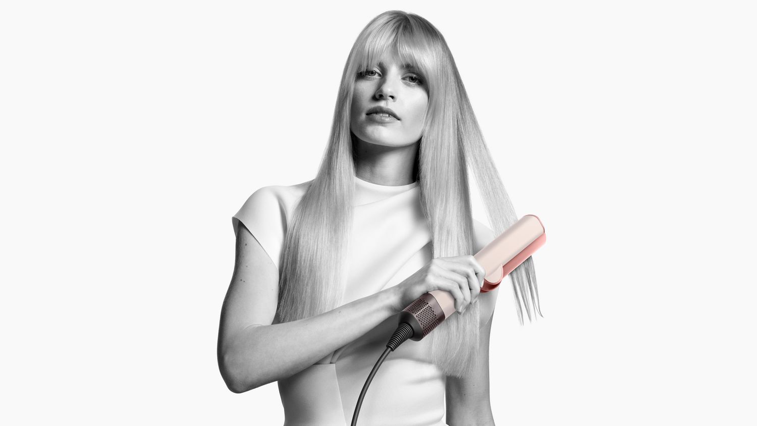 A model showing off her hair styled using the Dyson Airstrait straightener.