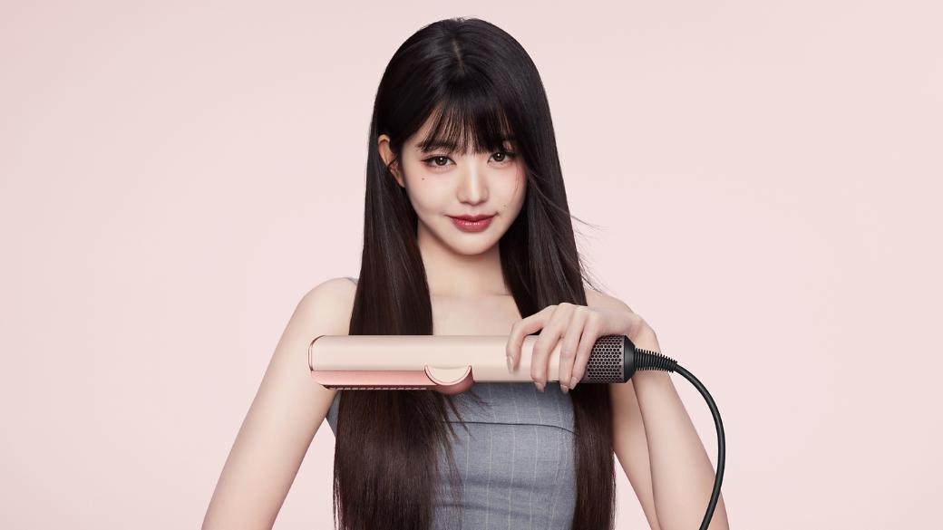 模特兒使用 Dyson Airstrait 二合一吹風直髮器,將頭髮由濕髮吹直。