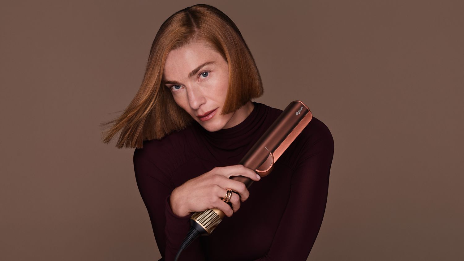 Model holds the Dyson Airstrait dryer and straightener.