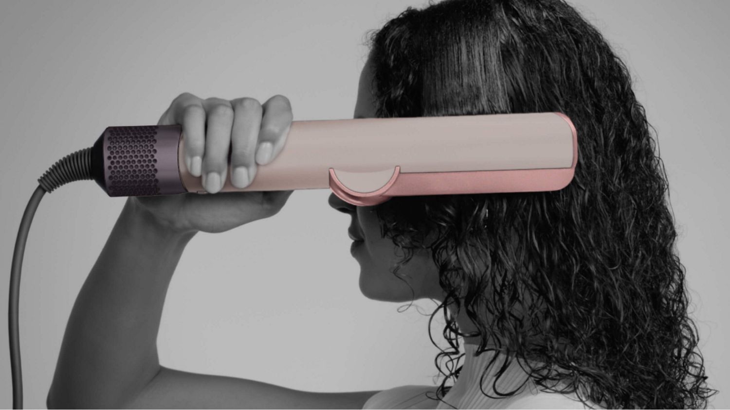  Model using the Dyson Airstrait dryer and straightener.