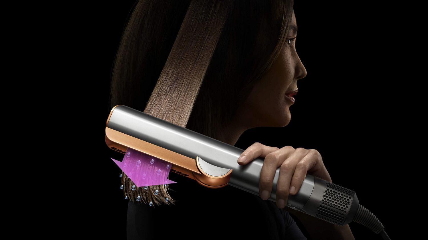 A model using the Dyson Airstrait dryer and straightener to straighten her hair from wet.