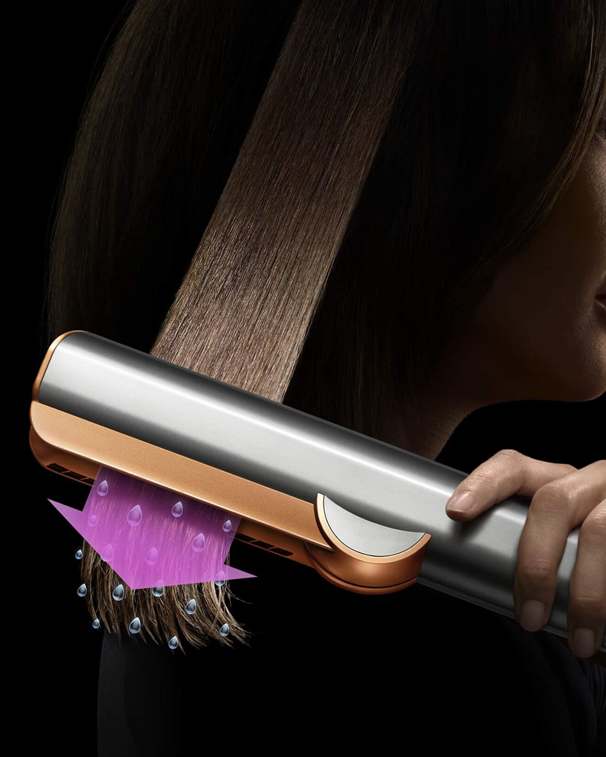 A model using the Dyson Airstrait dryer and straightener to straighten her hair from wet.
