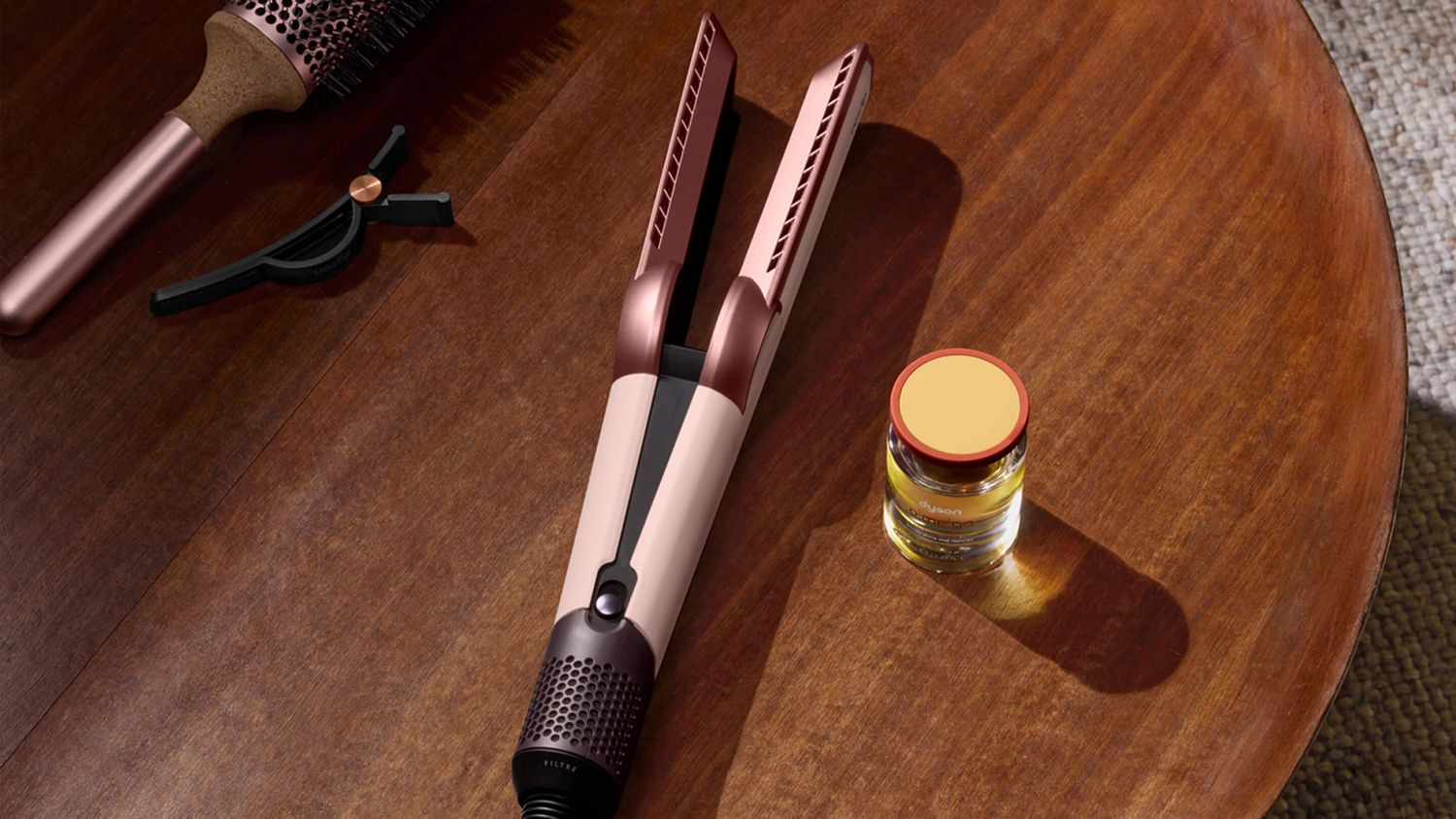 Dyson Airstrait dryer and straightener with Dyson Omega hydrating hair oil.