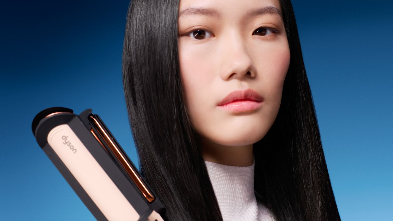 Model holding the Dyson Corrale CoolShine hair straightener.
