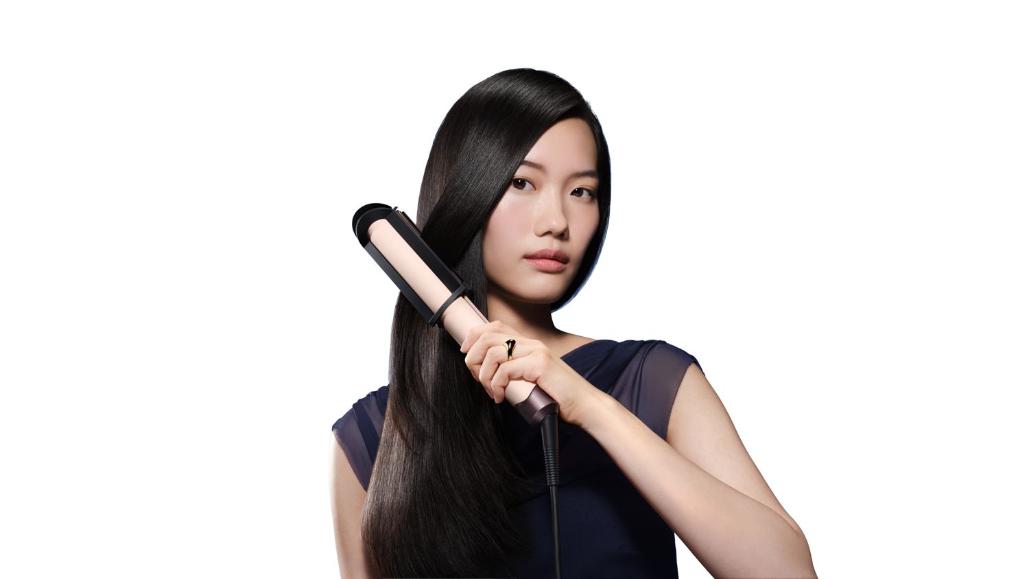 Model using the Dyson Corrale CoolShine hair straightener and cooling attachment.