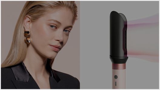 The Dyson Airwrap Co-anda2x multi-styler and dryer with the AirSmooth2x attachment next to a blonde model.