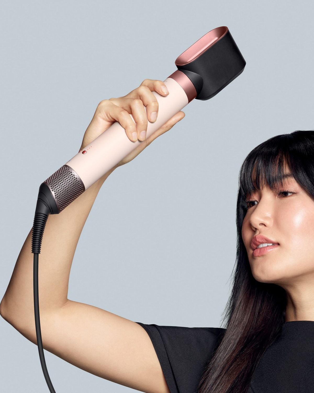 A model uses the Fast dryer 2x to rough dry her hair.