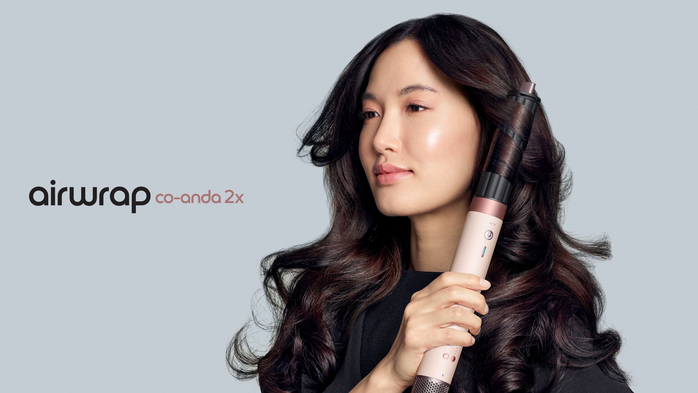 A model with dark hair adds curls using the Dyson Airwrap Co-anda2x multi-styler and dryer. The next-level multi-styler.