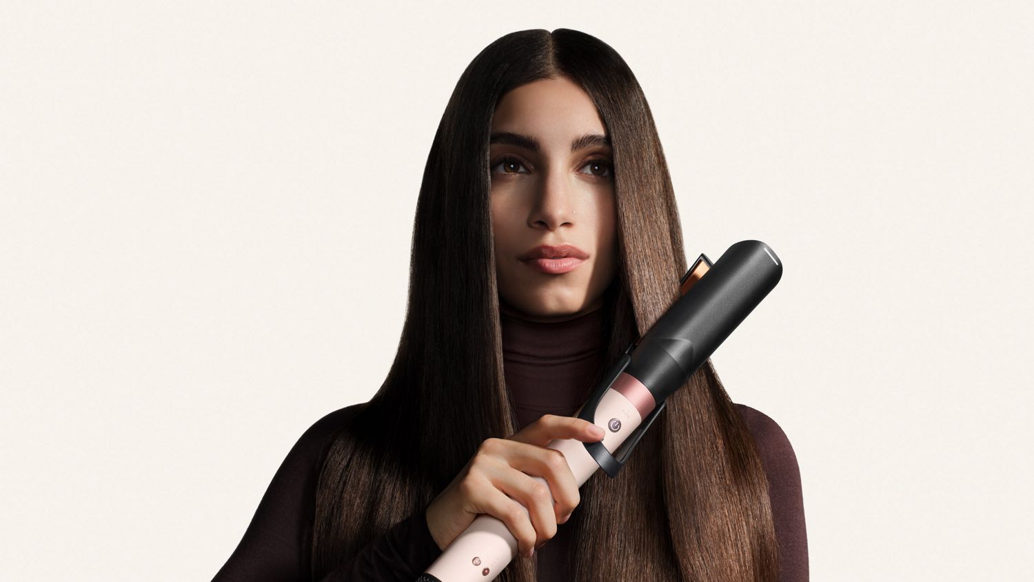 Model straightens her hair with the Dyson Air straightener 2x attachment.