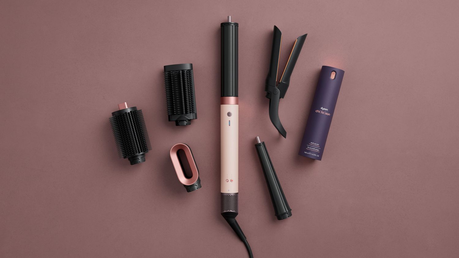 Dyson Airwrap Co-anda2x multi-styler and dryer surrounded by attachments and accessories.