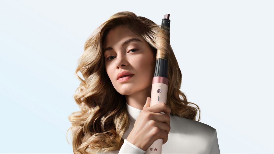 Model curls her hair with the Dyson Airwrap Co-anda2x multi-styler and dryer.
