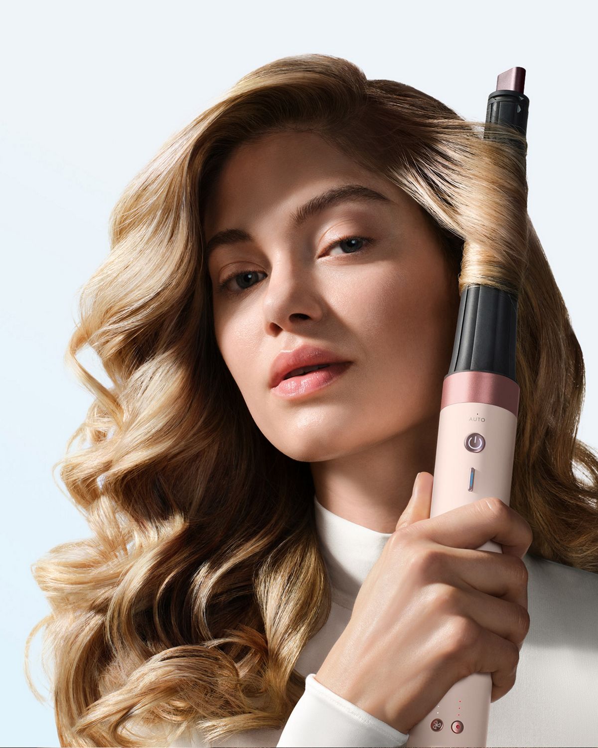 Model curls her hair with the Dyson Airwrap Co-anda2x multi-styler and dryer.