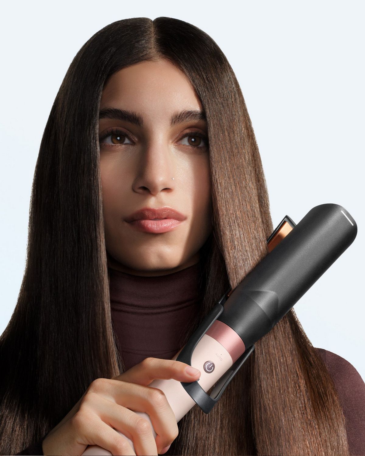 Model straightens her hair with the Dyson Air straightener 2x attachment.