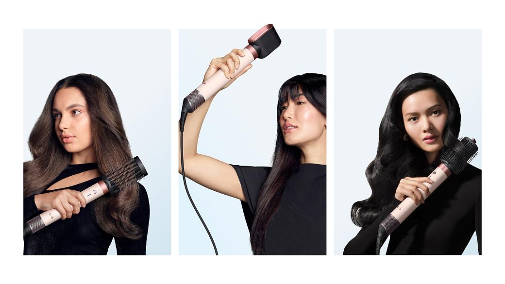 A trio of models dry and style their hair with the Dyson Airwrap Co-anda2x multi-styler and dryer.
