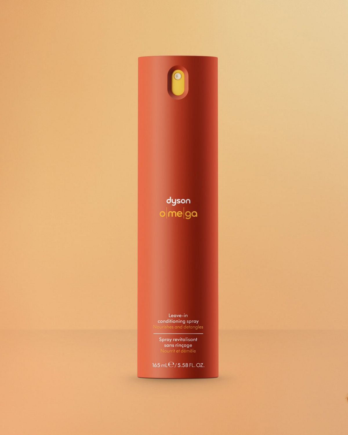 Dyson Omega™ leave-in conditioning spray next to a model with nourished hair.