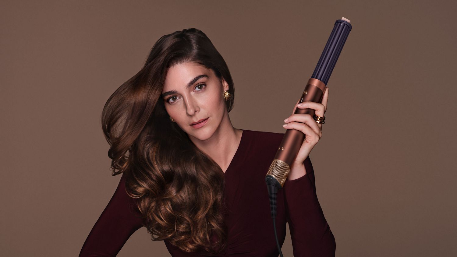 Model shows off hair styled with the Dyson Airwrap Co-anda2x multi-styler and dryer.
