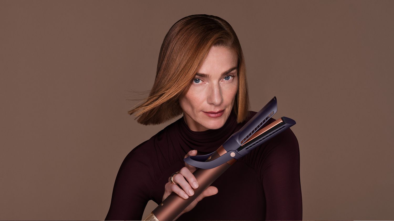 Model holds the Dyson Airwrap Co-anda2x multi-styler and dryer.