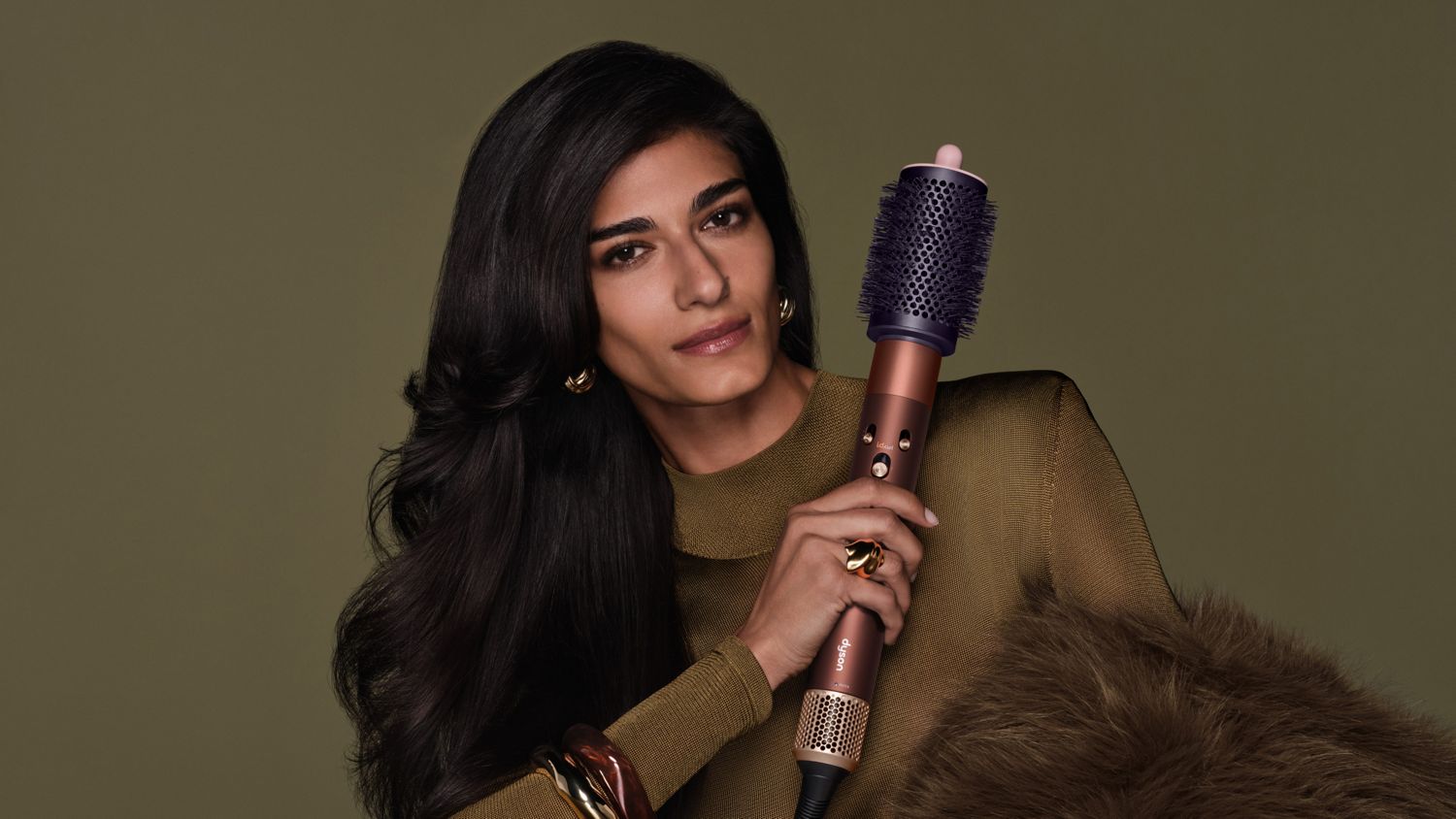 Model holds the Dyson Airwrap i.d. multi-styler and dryer.