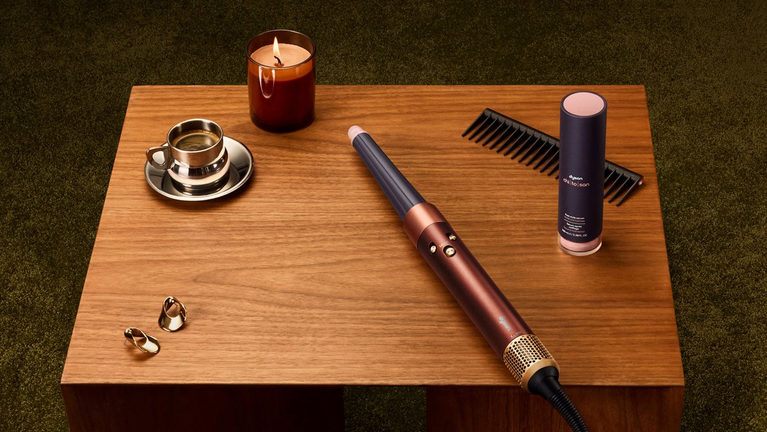 Dyson Airwrap i.d. multi-styler and dryer and Chitosan Post-style serum on a table.