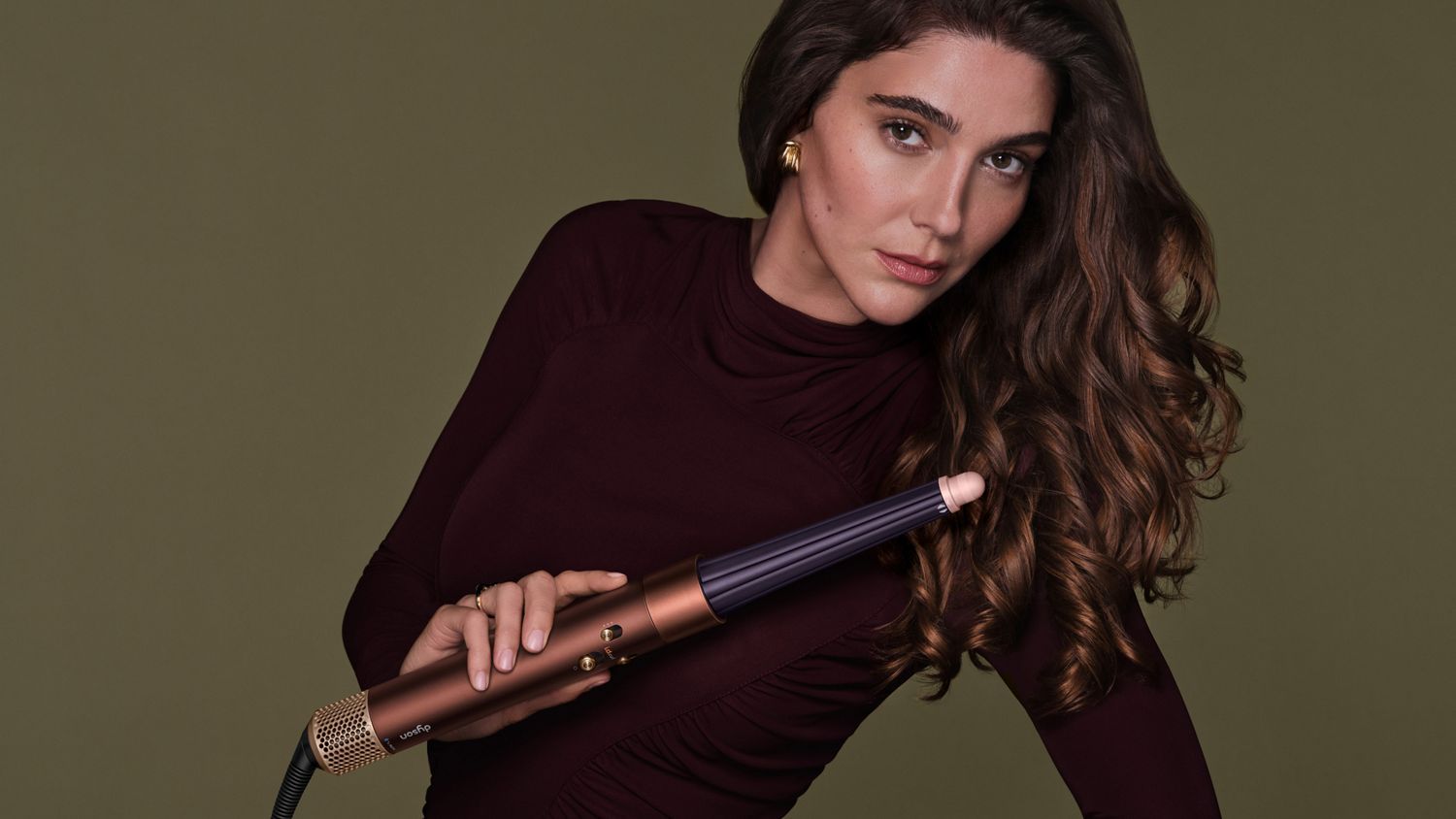 Model styles her hair with the Conical Airwrap barrel.