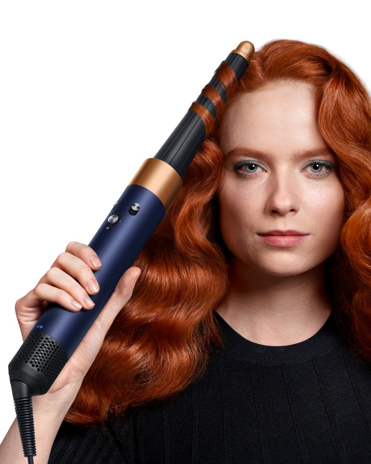 Front-on view of a woman curling her hair with the the Dyson Airwrap ID.