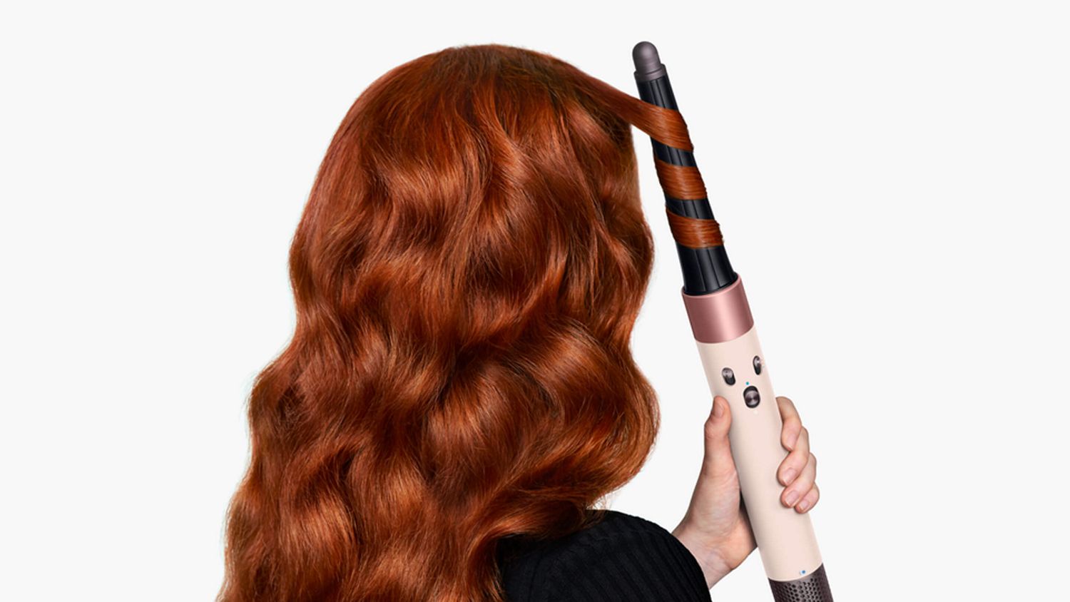 Model curls her hair with the Dyson Airwrap i.d. multi-styler and dryer.