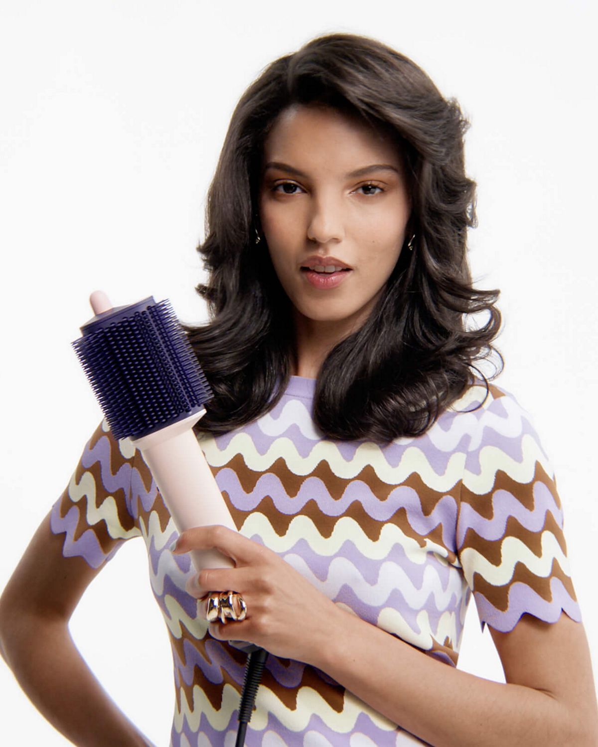   Model holds the Dyson Airsmooth styling brush.