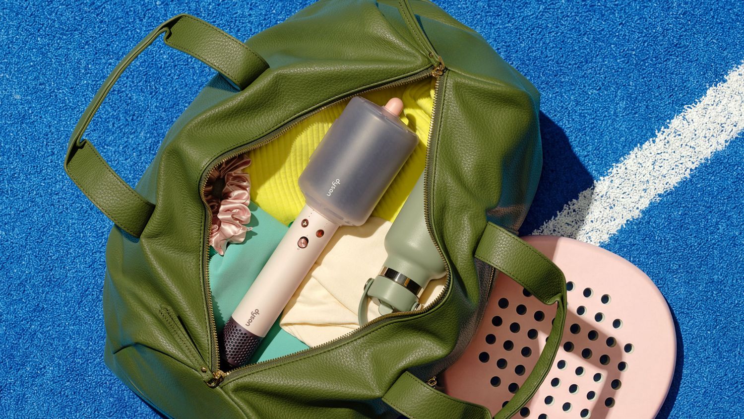 Dyson Airsmooth styling brush with bristle protector in a bag.