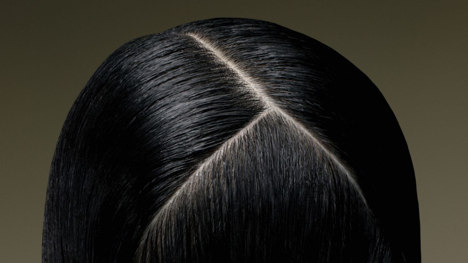 Close-up of the scalp of a model with hair treated using Dyson Amino scalp care.