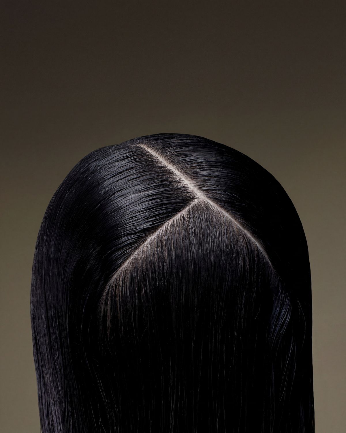 Close-up of the scalp of a model with hair treated using Dyson Amino scalp care.