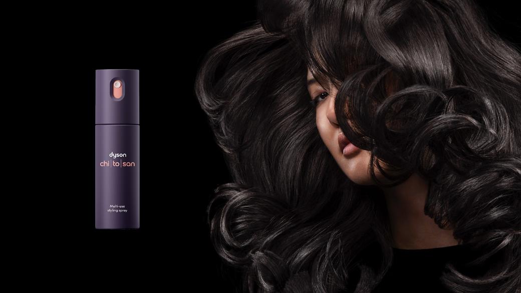 Dyson Chitosan Multi-use styling spray and a model with shiny black hair styled with Dyson Chitosan products.