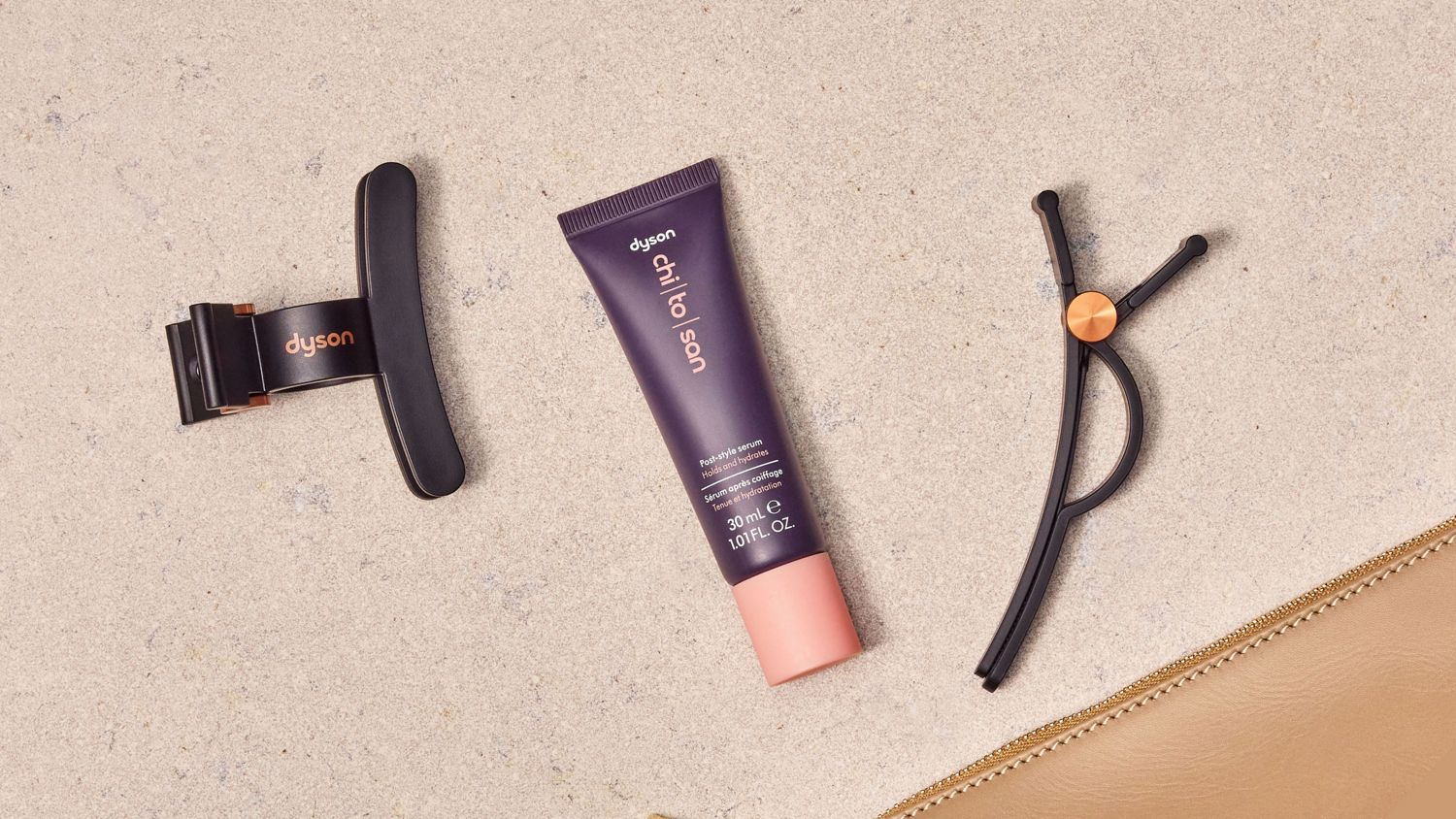 Dyson Chitosan Post-style serum travel mini with a pair of Dyson hair clips .