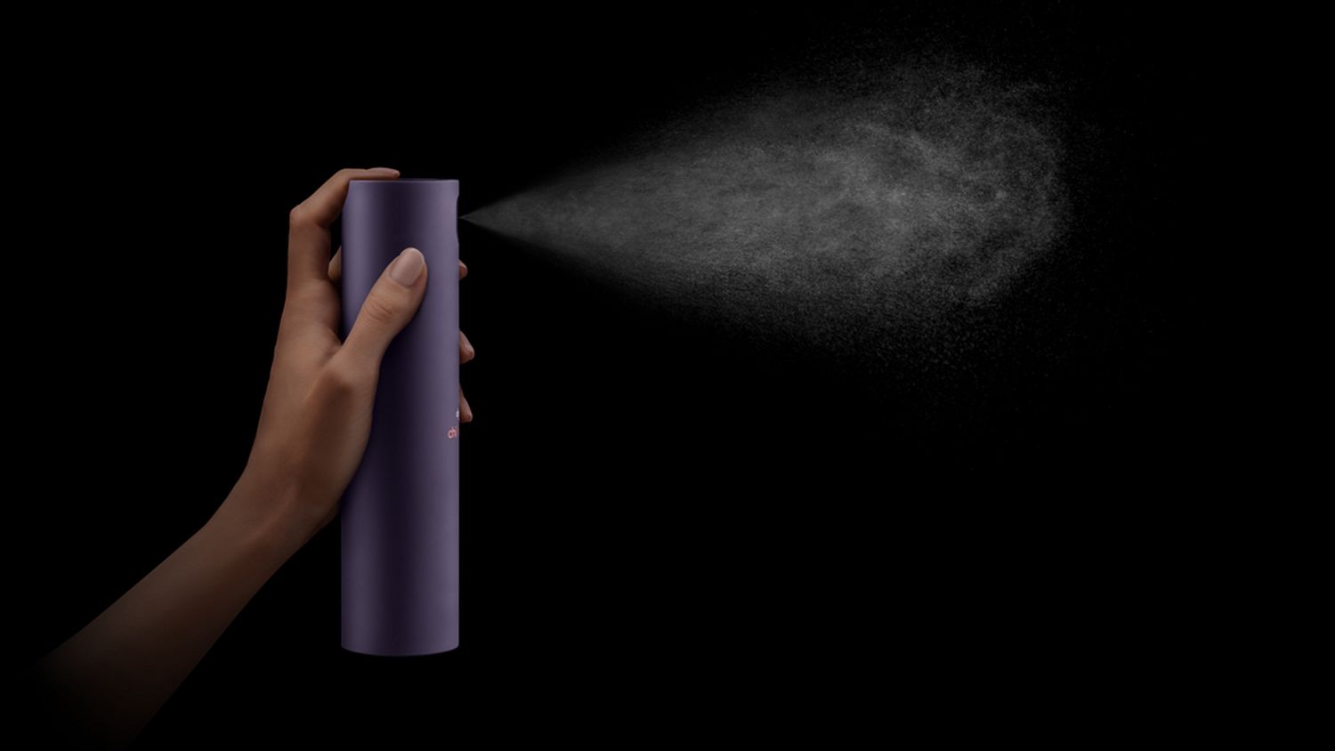 Dyson Chitosan Multi-use styling spray is sprayed against a black background.