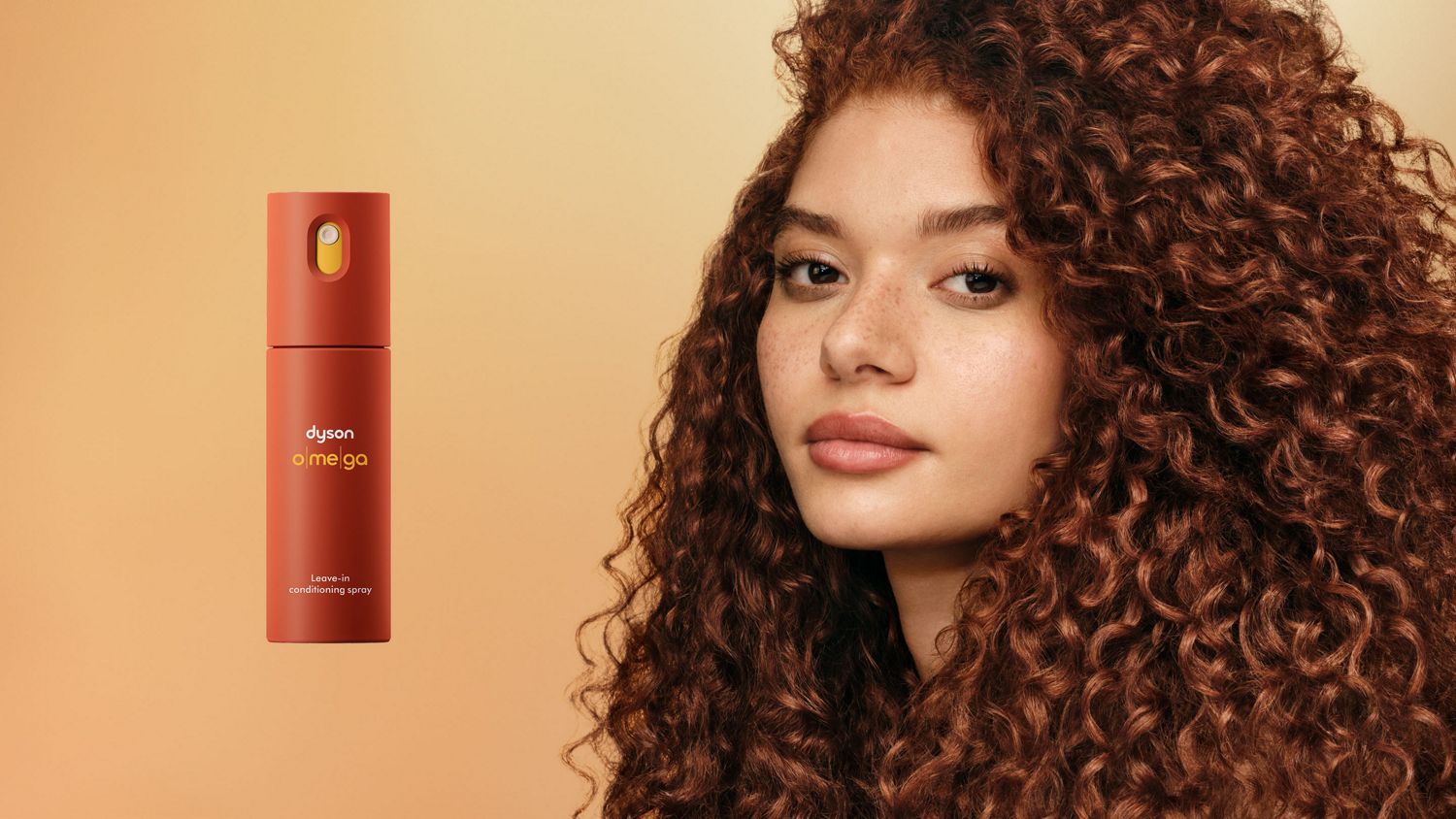 The Dyson Omega leave-in conditioning spray next to a model with styled curly hair.